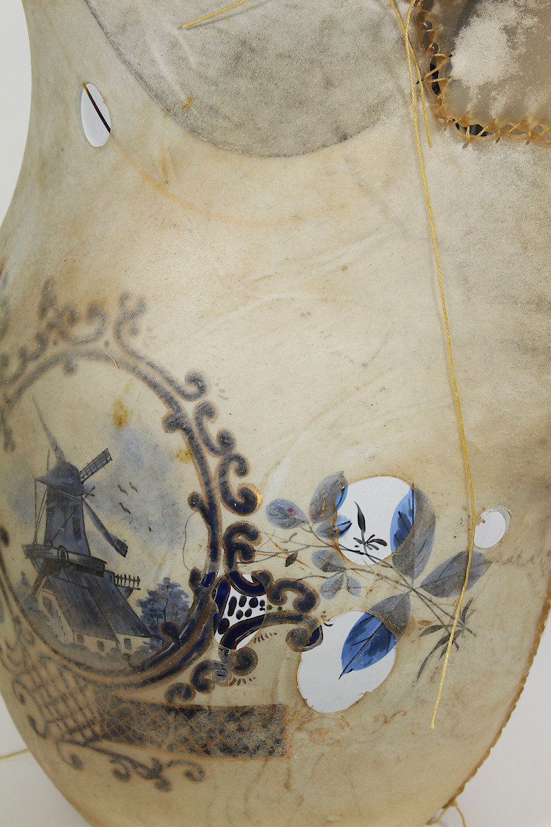 Contained (Pitcher), 2016, enamelled pitcher, rawhide, thread, 9.5 x 7.0 x 12.5 in